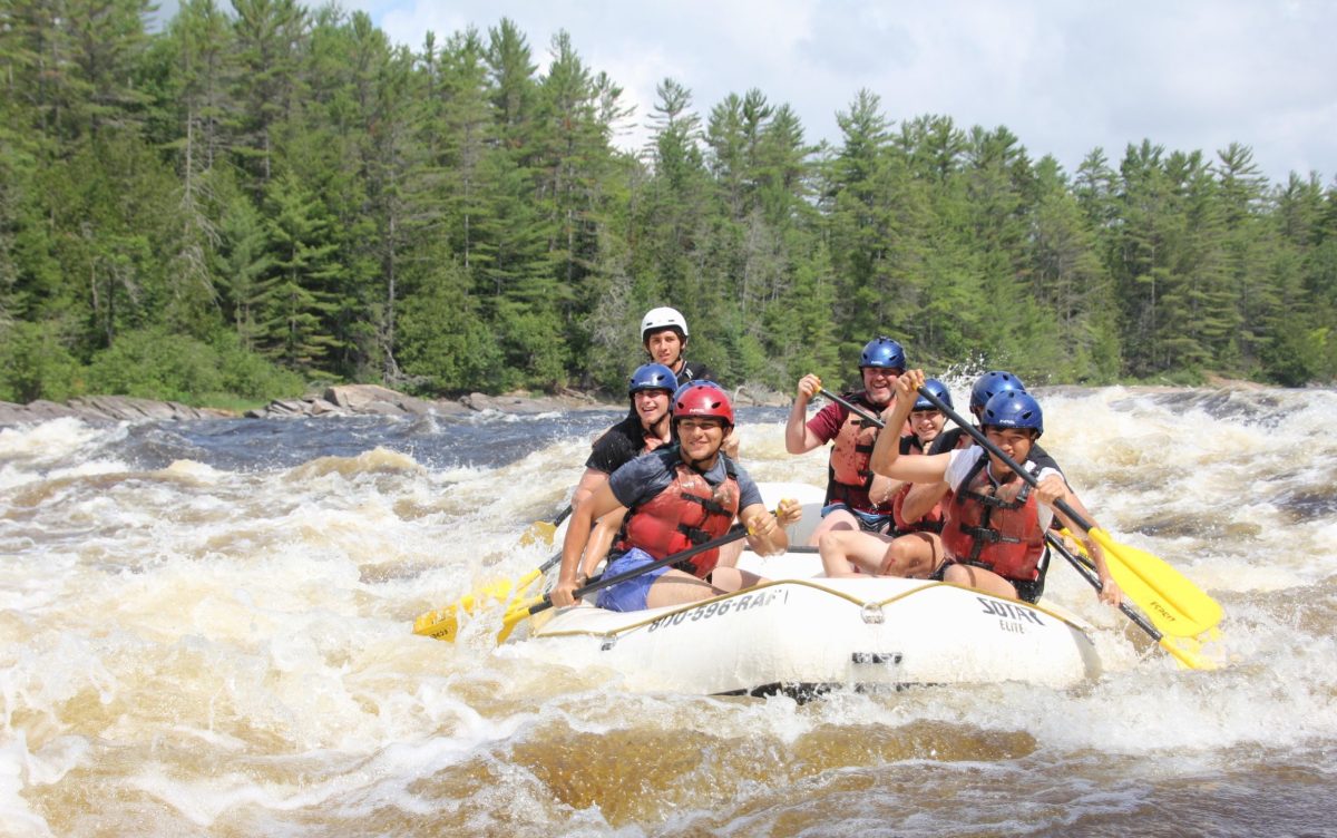 a group of people riding skis on a raft