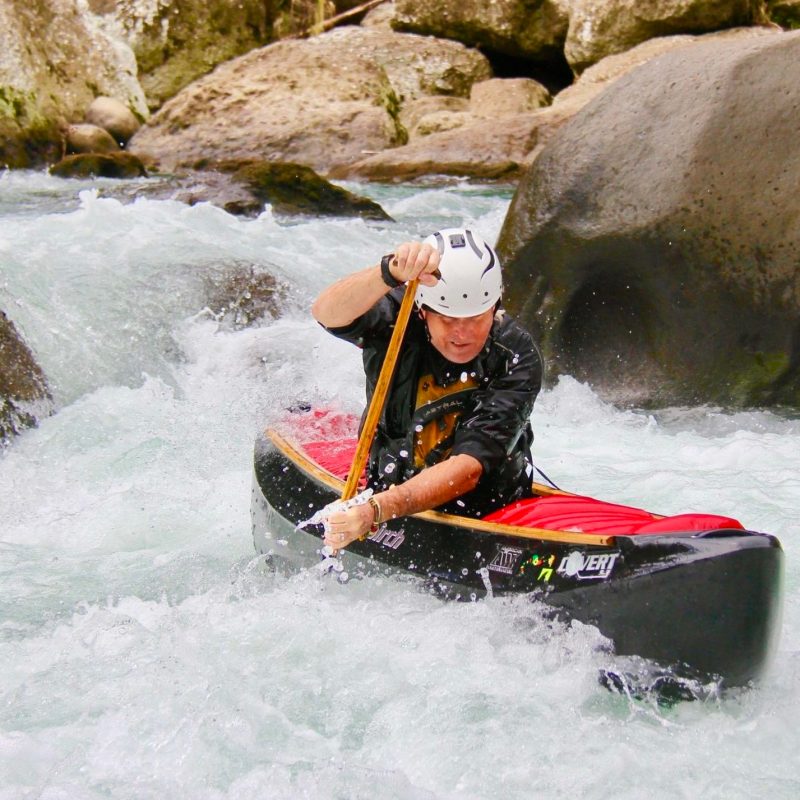 man canoeing on white waters