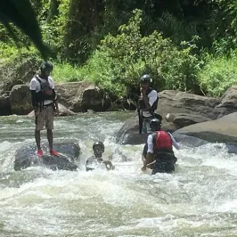 a group of people crossing a river