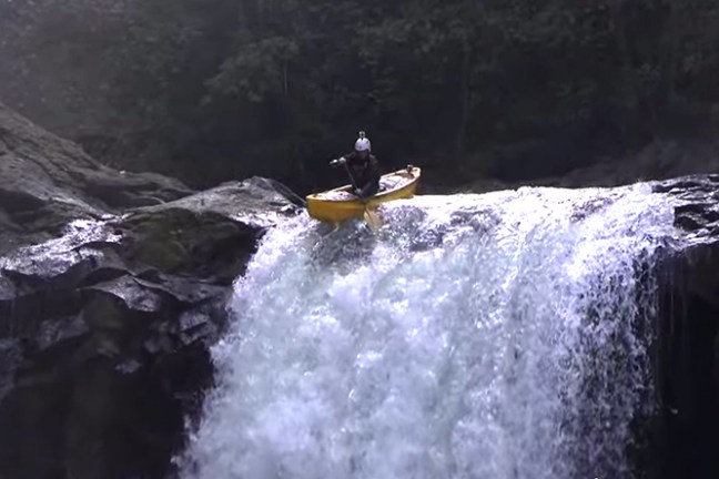 a man riding a wave on top of a mountain