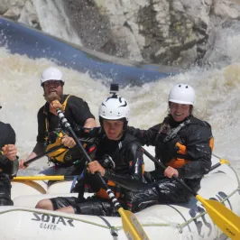 a group of people on a raft in the snow