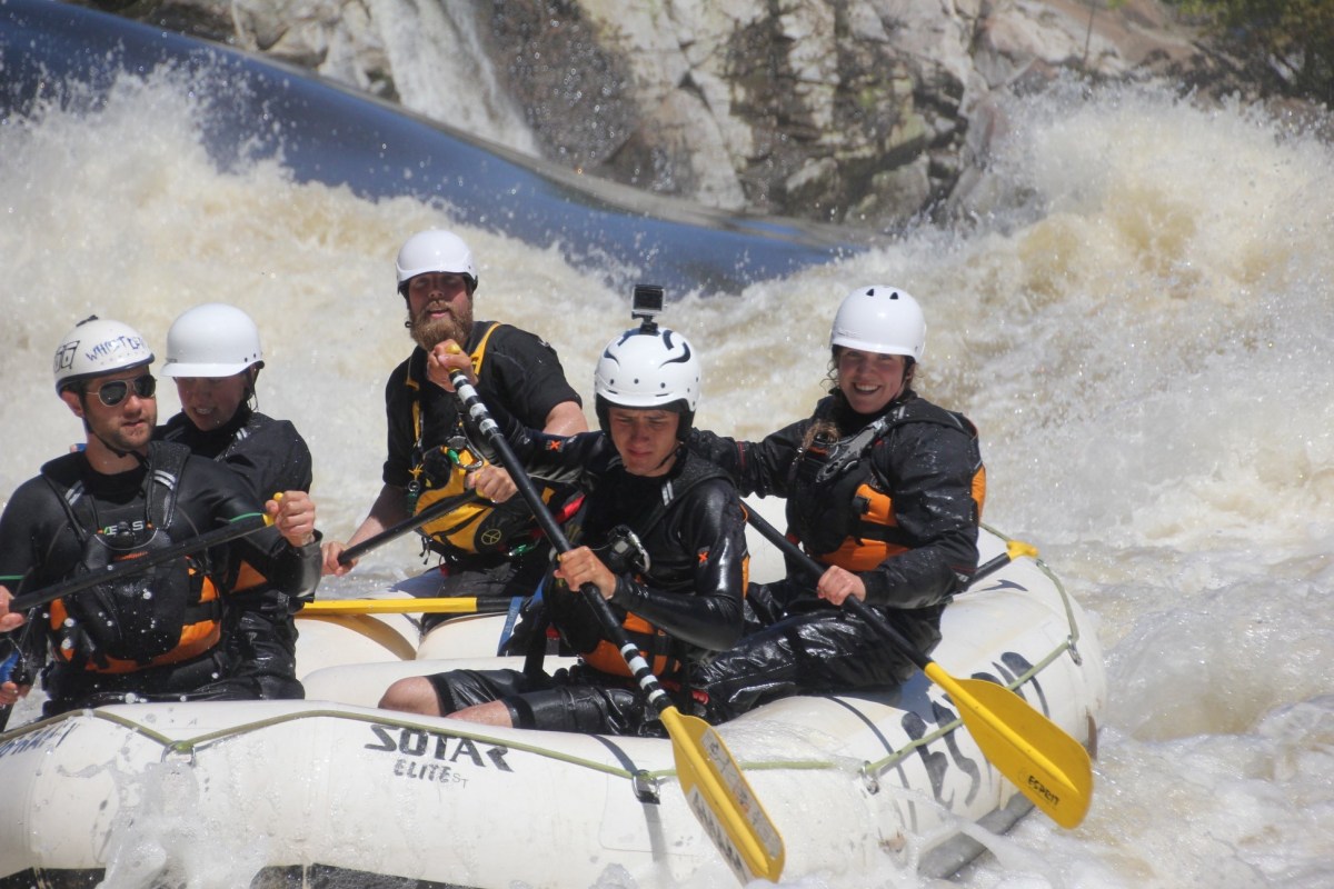 a group of people on a raft in the snow