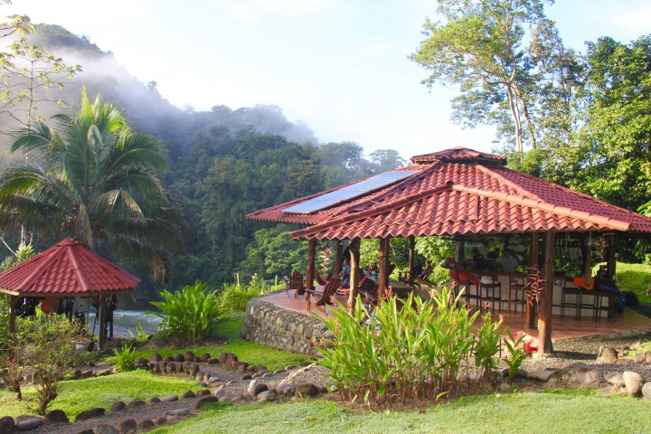 a house that has a umbrella in a garden