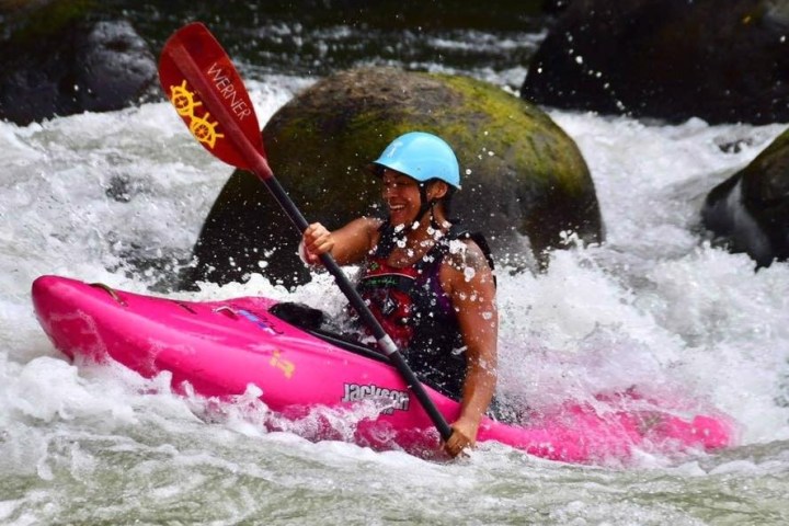 a man riding a wave on top of a body of water