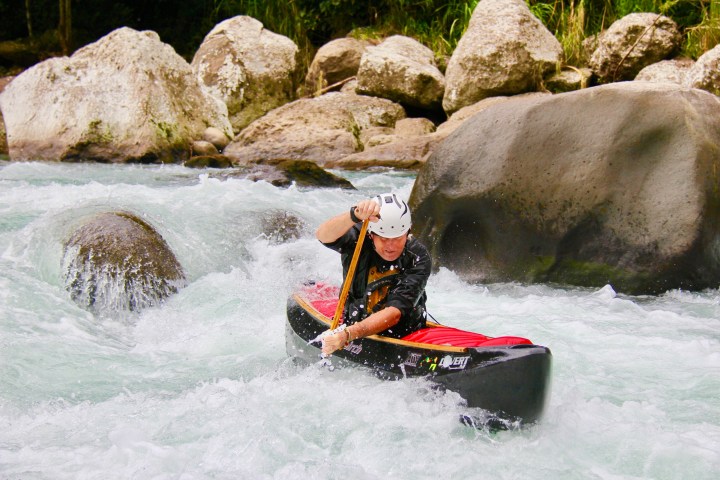 a man riding a wave on a surfboard in the water