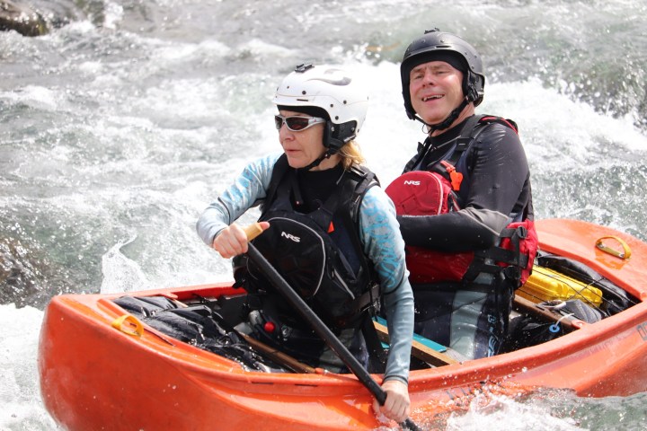 a man sitting on a raft in a body of water