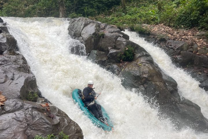 a person standing next to a waterfall