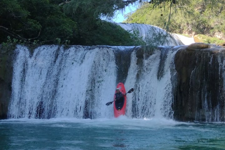 a large waterfall over some water